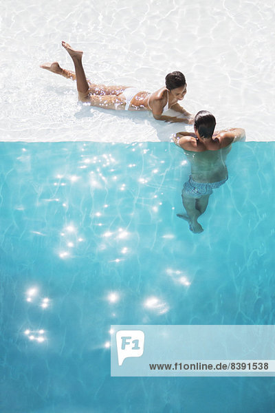 Couple relaxing in swimming pool