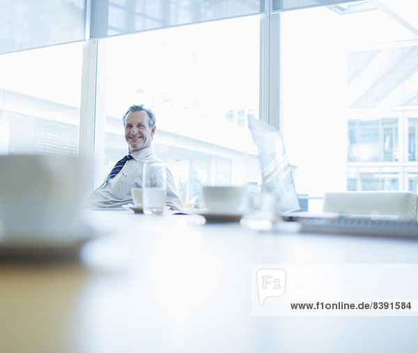 Businessman smiling in conference room