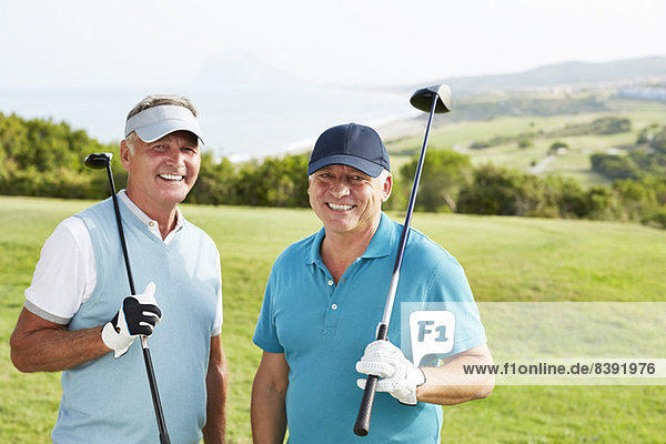 Smiling senior men on golf course