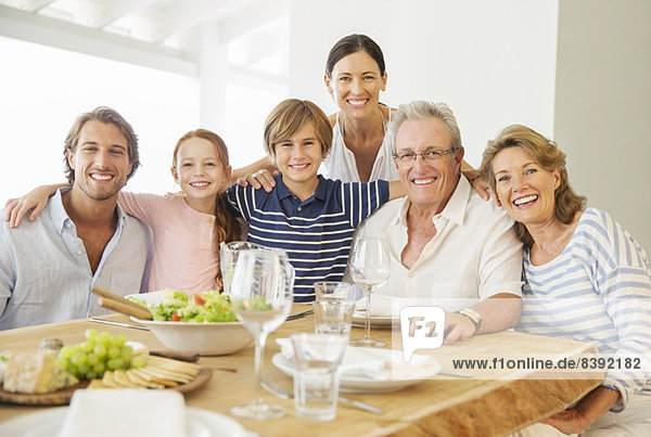 Multi-generation family smiling together at table