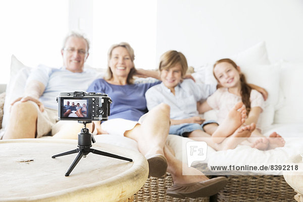 Family taking picture of themselves on sofa