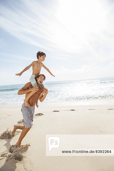 Father and son playing on beach