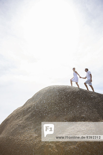 Couple walking on rock formation