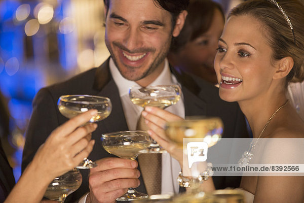 Close up of couple toasting champagne glasses