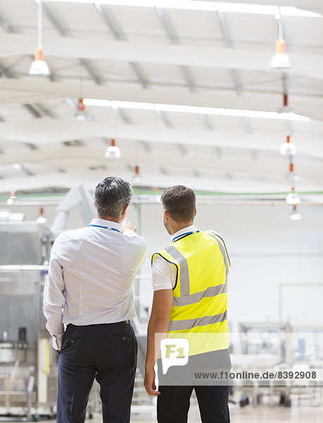 Supervisor and worker talking in warehouse