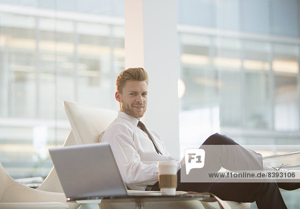 Businessman using laptop in office