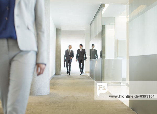 Businessmen walking in office corridor