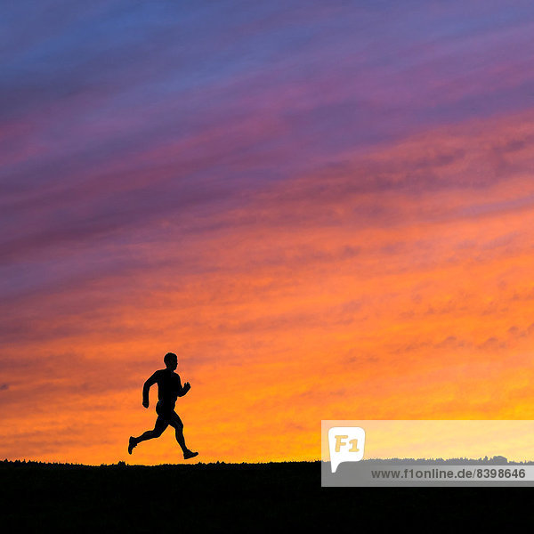 Silhouette eines Joggers im Sonnenuntergang