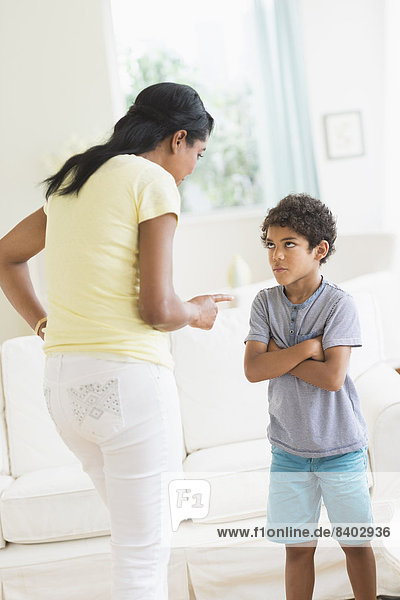 Mother scolding son in living room