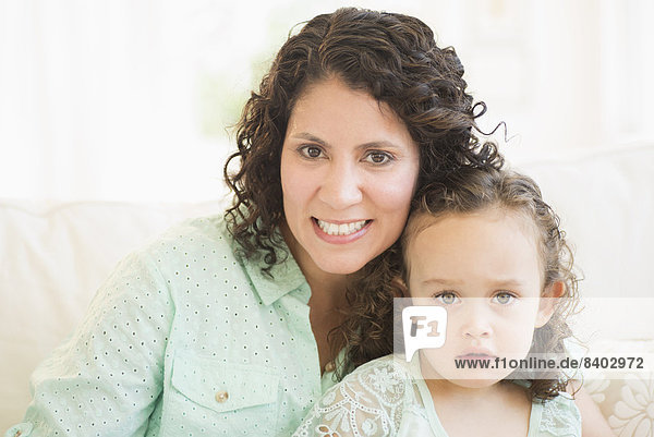 Mixed race mother smiling with daughter