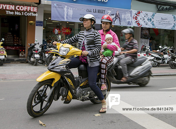 Two women with child on a motorcycle  Ho Chi Minh City  Vietnam