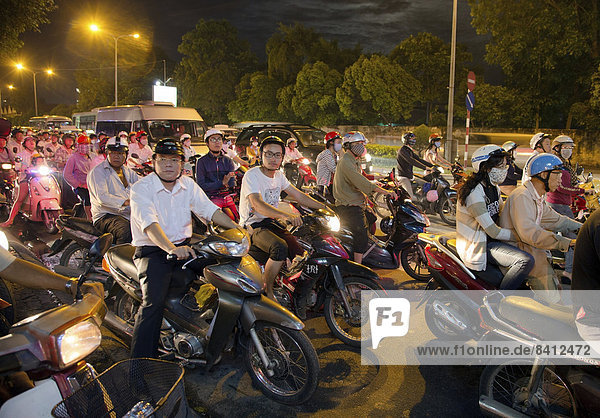 Many motorcyclists  traffic  at dusk  Ho Chi Minh City  Vietnam