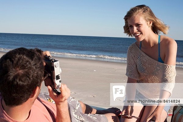 Couple photographing on beach  Breezy Point  Queens  New York  USA