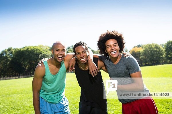 Portrait of three young men smiling
