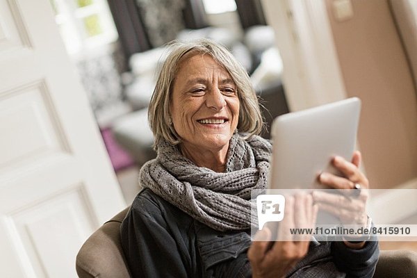 Senior woman with digital tablet