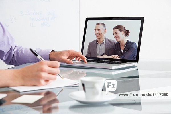 Businessman on video conference with two colleagues
