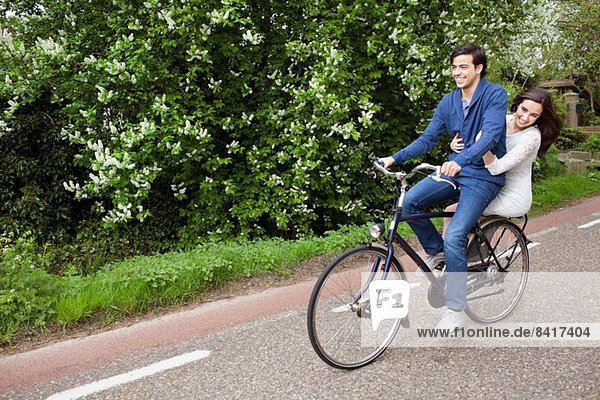 Young couple enjoying cycle ride