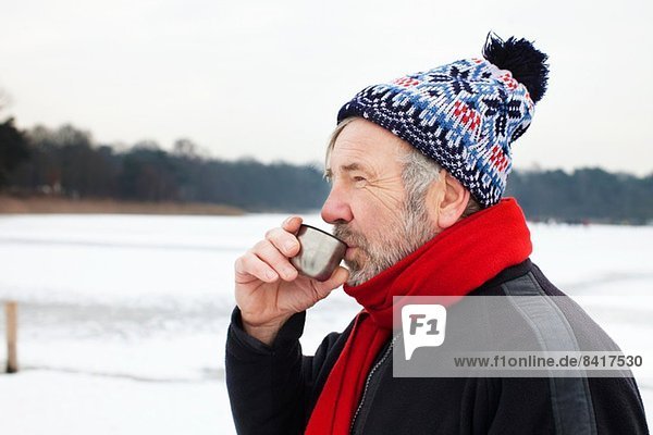 Man outdoors having hot drink