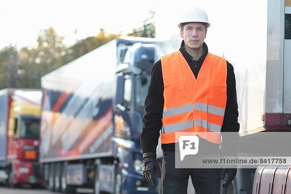Builder standing in front of truck