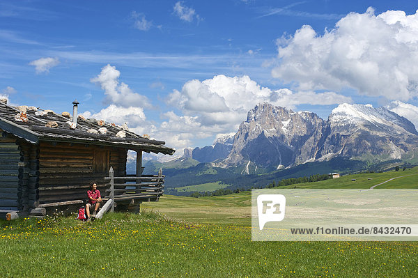 South Tirol  Italy  Europe  Seiser Alm  Langkofel  Dolomites  mountain landscape  mountains  scenery  nature  Trentino  alpine hut  mountain hut  hut  alp  flower meadow  flowers  spring  spring  woman  traveler  traveller  activity  active  leisure  activity  spare time  leisure  activity  hobby  person  Outdoor  sport  sporty  walk  hiking  outside  day