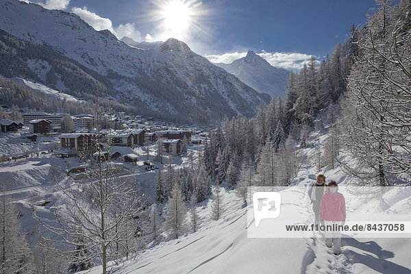 Switzerland  Europe  village  couple  couples  woman  man  two  snow  footpath  trail  hiking path  walking  hiking  winter  winter sports  canton  Valais  Zinal  Val d'Anniviers