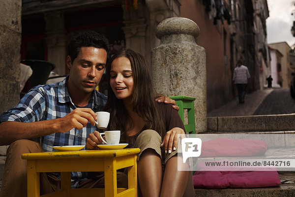 Portugal  Lisboa  Bairro Alto  young couple sitting at street cafe at dusk
