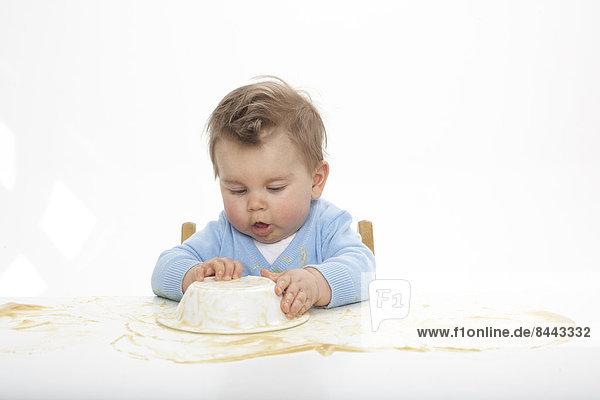 Baby boy covering table with pap  studio shot