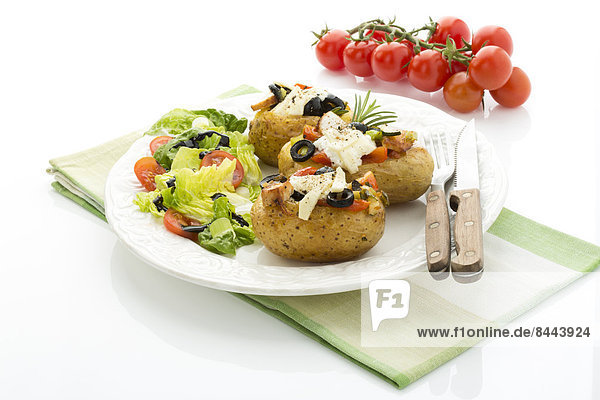 Mediterranean baked potatoes with tomatoes  spring onions  olives  chicken  ricotta and parmesan cheese