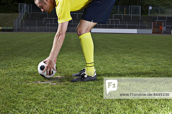 Soccer player placing ball on penalty spot