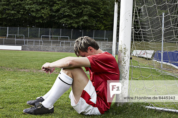 Frustrated soccer player on field