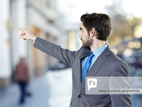 Young businessman pointing on something