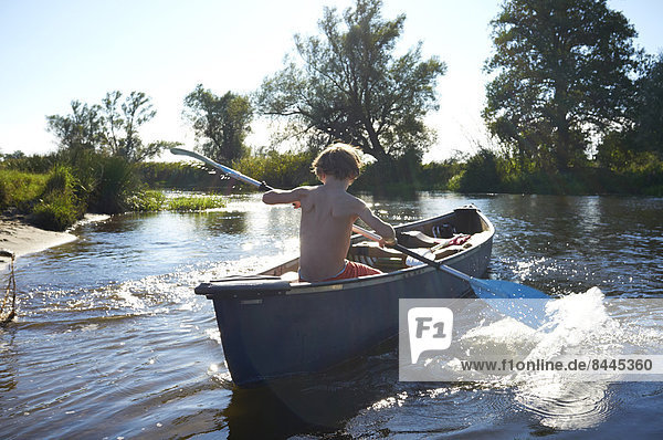Boy paddeling on Spree river