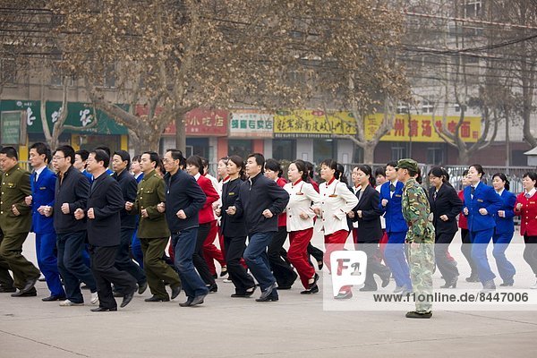 Staff on morning exercise in the grounds of the Shaanxi History Museum  Xian  China