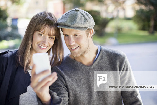 Young couple taking self portrait photography outdoors