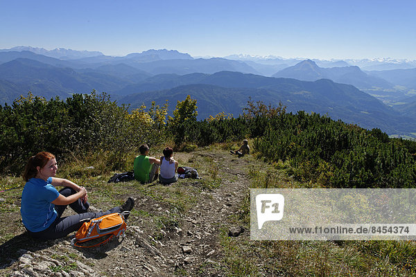 Hikers resting at the top of the Hochplatte  Chiemgau  Upper Bavaria  Bavaria  Germany