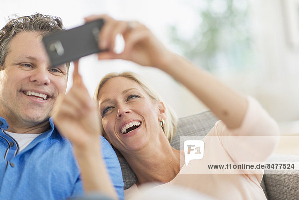 Couple taking self-portrait photo with smartphone