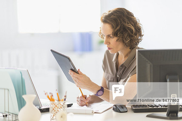 Business woman using digital tablet  laptop and computer