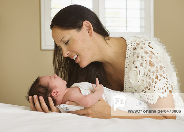 Portrait of mother holding newborn baby (0-11 months)