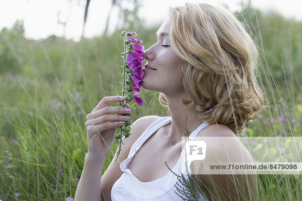 Portrait of happy woman with purple flower