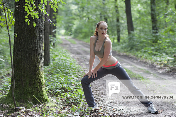 Woman stretching in forest