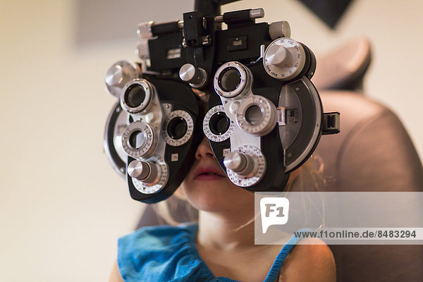 Caucasian girl receiving eye exam