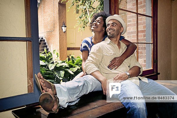 Couple relaxing together in windowsill