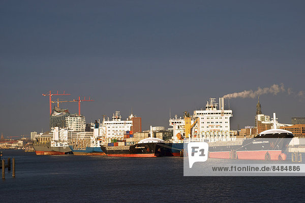 Ships in the Port of Hamburg at anchor in the North Elbe  Elbe Philharmonic Hall and the Marco Polo Tower in the back  Hamburg  Germany