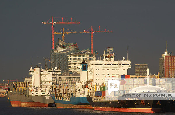 Ships in the Port of Hamburg at anchor in the North Elbe  Elbe Philharmonic Hall and the Marco Polo Tower in the back  Hamburg  Germany