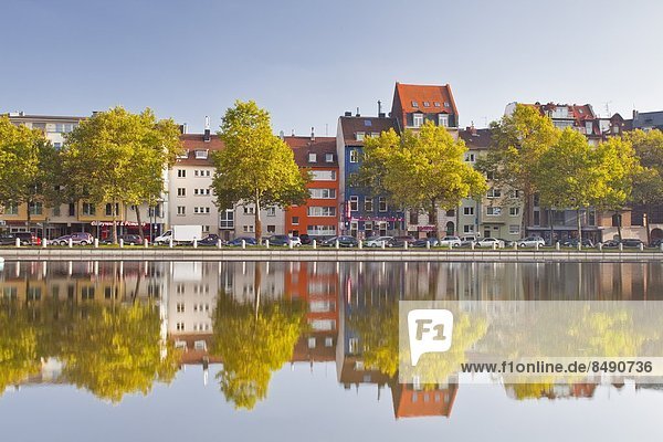 Houses and shops reflecting in a pond  Cologne  North Rhine-Westphalia  Germany  Europe MediaPark development looking across to Maybachstrasse. The pond is part of the Mediapark.
