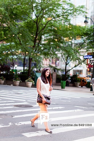 Young woman crossing street  New York City  USA
