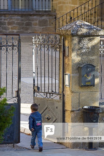 Young boy arrives at school in traditional Basque town of Laguardia in Rioja-Alavesa area of Spain