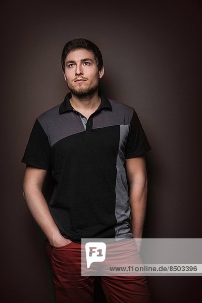 Portrait of young man wearing t shirt with hands in pockets