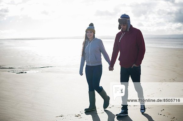 Young couple walking on beach  Brean Sands  Somerset  England