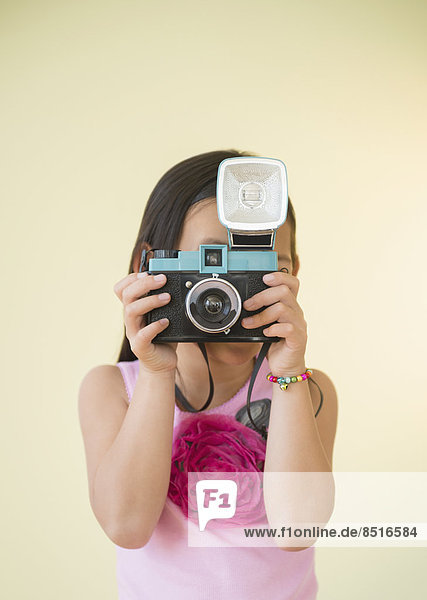Korean girl using retro camera